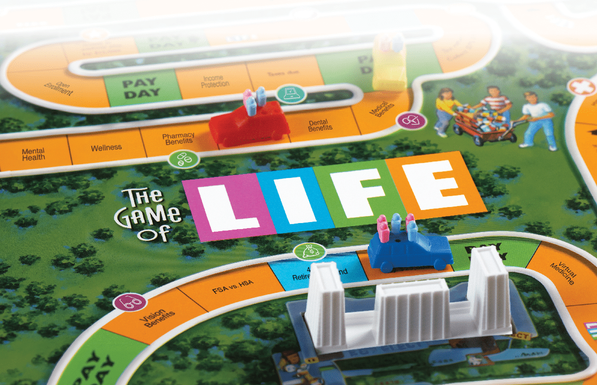 Oxford, Connecticut, United States - September 6, 2011: Playing, The Game of Life. Life is a board game originally created in 1860 by Milton Bradley. Later reproduced by the Milton Bradley Company in 1960. Life was America\'s first popular parlor game and is still very popular today. In this board game the player\'s travel around the board in a car. Along the way they will find themselves leaving college and choosing a carrer as well as getting married and possibly having children. The game ends when the players make it to retirement. There are many ups and downs during the game such as having to pay taxes, winning the lottery, having your salary change,  simulating real Life.